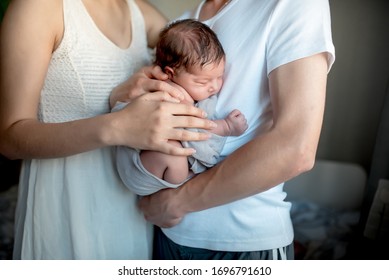 Newborn Baby With Mom And Dad At Home
