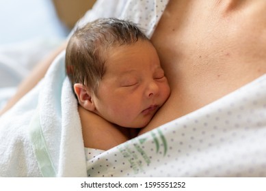 newborn baby in mother's arms