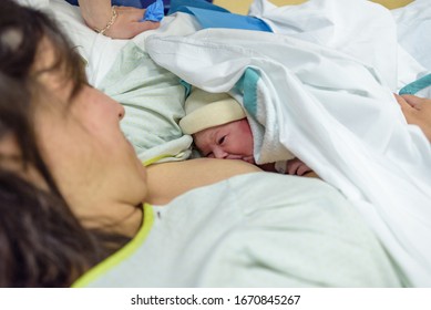 Newborn baby in mother's arms