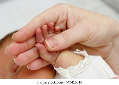 Newborn Baby In Mother's Hands Grip