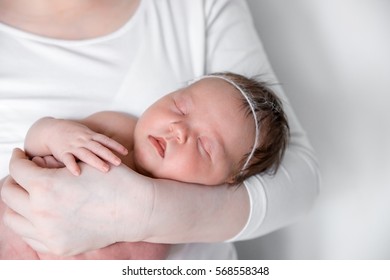 Newborn baby on hands at mum. - Shutterstock ID 568558348