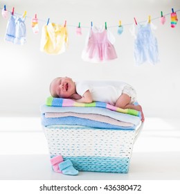 Newborn Baby On A Pile Of Clean Dry Towels. New Born Child After Bath In A Towel. Family Washing Clothes. Kids Wear Hanging On A Line. Infant Apparel, Textile For Children. Smiling Boy After Shower. 