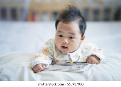 Newborn Baby Play Smart Phone On The Bed, Baby, Family And Technology Concept