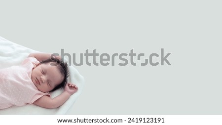 Newborn lying on bed embraced by her mother