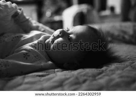 Newborn baby. Portrait (monochrome montage with vertical contrast film)