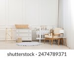 Newborn baby room interior with stylish furniture and comfortable crib