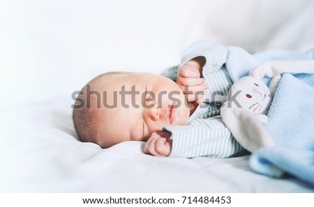 Newborn baby sleep first days of life. Cute little newborn child sleeping peacefully