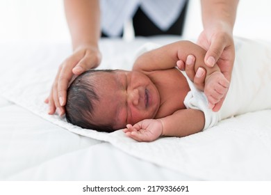 Newborn Baby Sleep On Bed. Newborn Baby Sleeping On White Bed While Mother Hands Takes Care Carefully. Family, Love And New Life Concept