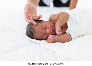 Newborn Baby Sleep On Bed. Newborn Baby Sleeping On White Bed While Mother Hands Takes Care Carefully. Family, Love And New Life Concept