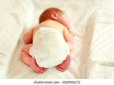 Newborn Baby Sleeping In A Diaper On A Changing Table.