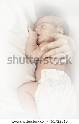 Similar – Newborn baby girl sleeping lying on blanket on bed