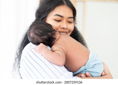 Newborn Baby Sleeping On Mother Shoulder. African American Mom Comforting Her Baby