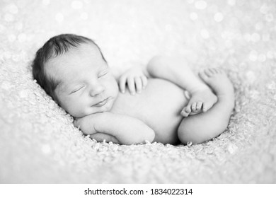 Newborn Baby Sleeping On Wool Blanket. Happy Baby, Sleep Time. Black And White Picture

