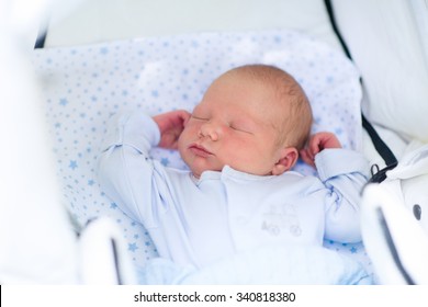 Newborn Baby Sleeping In White Stroller On A Walk In Summer Park. New Born Child Napping Outdoors On Hot Sunny Day. Infant In A City Buggy. Kids Sleep In Pram. Close Up Portrait Of Cute Little Boy.