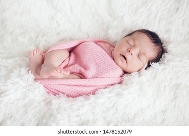 newborn baby sleeps wrapped in a blanket. concept of childhood, healthcare, IVF