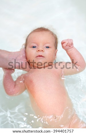 Similar – Image, Stock Photo Newborn in the bathtub held by her mother