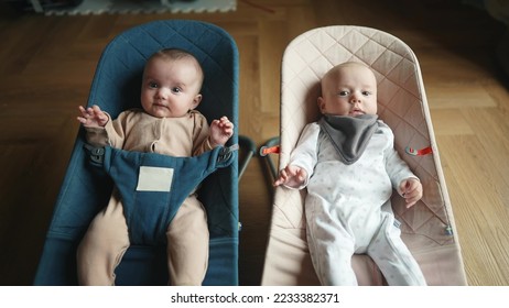 newborn baby twins in a rocking chair. happy family kid dream concept. portrait twins newborn baby child. twins baby lies in a rocking chair lifestyle at home in a room indoors - Powered by Shutterstock