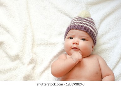 Newborn Baby Wear Handmade Fabric Hat On Towel With Sunlight Shading