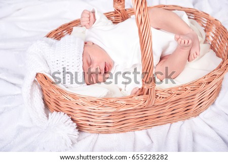 Similar – Baby lying in a wicker basket