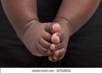 Newborn baby's feet. A closeup with a candid appeal. The baby skin is african brazilian tone.