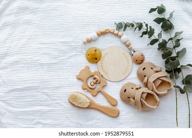 Newborn Booties With Empty Card And Wooden Toys. Baby Background, Top View, Flat Lay, Copy Space 