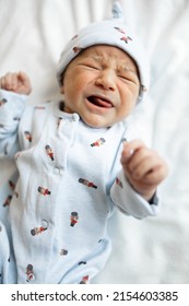 Newborn Boy Crying Portrait On Bed