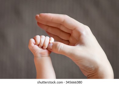 Newborn children's hand  in mother hand. Mom and her Child. Happy Family concept. Beautiful conceptual image of Maternity   - Shutterstock ID 345666380