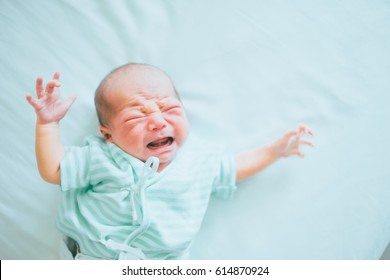 Newborn Crying Baby Boy.New Born Child Tired And Hungry In Bed.Children Cry.Bedding For Kids.Infant Screaming.Healthy Little Kid Shortly After Birth. 