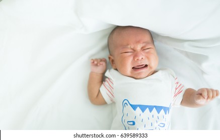 Newborn Crying Baby Boy.New Born Child Tired And Hungry In Bed.Children Cry.Bedding For Kids.Infant Screaming.Healthy Little Kid Shortly After Birth.