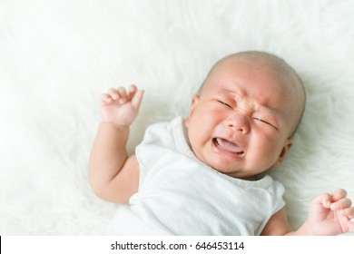 Newborn Crying Baby Boy.New Born Child Tired And Hungry In Bed.Children Cry.Bedding For Kids.Infant Screaming.Healthy Little Kid Shortly After Birth.