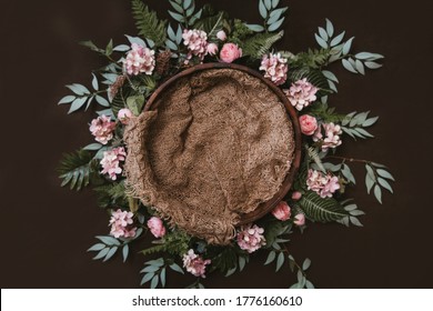 Newborn digital background - brown wooden bowl with green leaves wreath and jute layer.