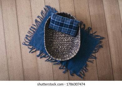 Newborn digital background -  brown woven bowl with blue plaid pillow and blue layer on wooden background