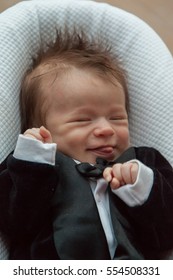 Newborn Hairy Baby In Tuxedo Grimacing