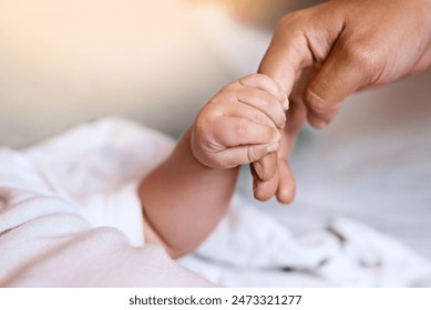 Newborn, hands and holding fingers with person in house, wellness and affection together for family bonding with baby. Bedroom, parent and relax with infant for care, childhood and growth with love - Powered by Shutterstock