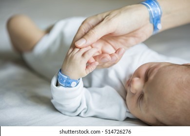 Newborn and his mom with name tag bracelets, first days of life