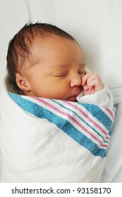 Newborn Infant Baby sleeping wrapped in blanket