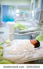 Newborn Infant Sleeping In Hospital Bassinet