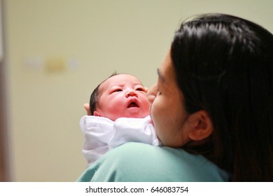 Newborn And Mom.My Mother's Eyes Look At The Baby.Mom Is Watching Her Baby With Love.
This Is The Time Where Women Need Care & Compassion.