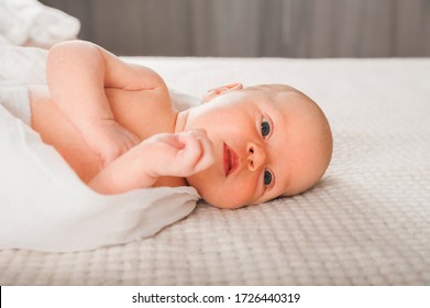 Newborn On The Bed. Crying, Screaming Baby Close Up And Copy Space. Baby Smile And Colic In Newborns. Seborrheic Dermatitis In Newborns