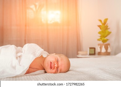 Newborn On The Bed. Crying, Screaming Baby Close Up And Copy Space. Baby Smile And Colic In Newborns. Seborrheic Dermatitis In Newborns