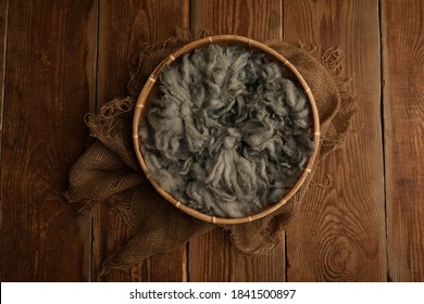 Newborn photography digital background prop. wood basket with green fur and on a wooden background
