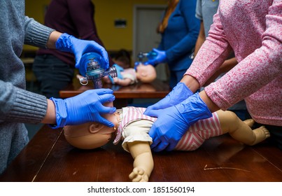 Newborn resuscitation on a infant dummy doll. First help medical class. - Powered by Shutterstock