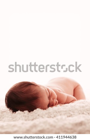 Similar – Newborn baby girl sleeping lying on blanket on bed