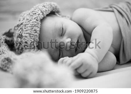 Similar – Image, Stock Photo Newborn baby with pompom hat sleeping and laughing on blanket