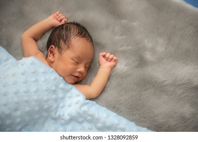 Newborn Sleeping  On A Mink Fur  Blanket In Cute Props. Infant Baby