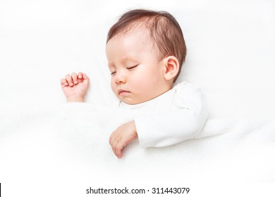 Newborn Sleeping On The White Bed, New Family And Baby Protection Concept