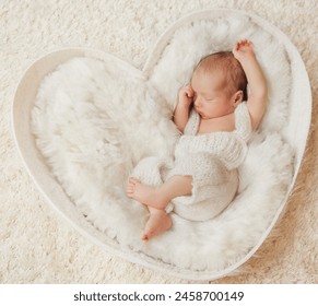 Newborn sleeping on White Fur Blanket. Baby lying in Cradle. Infant Child sleep on Heart shaped Pillow over fluffy Beige Carpet - Powered by Shutterstock