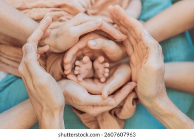 Newborn tiny hand surrounded by family. Symbol of love, protection, and strong family bonds. Parenthood, childhood, and unconditional love concept