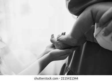 Newborn Tiny Legs. Sister Holding Little Feet. Two People. Healthcare Concept. Unrecognised Modern Parenthood. Comfort And Safety Sleep. Human Insurance. Family Miracle. No Face