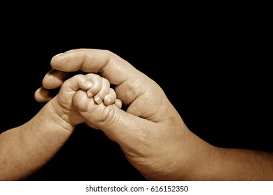 newborn trusts in adult hand - Shutterstock ID 616152350